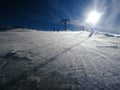 Stormy wind on the ski slope, skiers sliding down the mountain