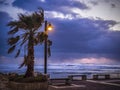 Stormy wind weather on the shores of the Mediterranean Sea, twilight, burning lantern. Royalty Free Stock Photo