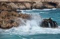 Stormy windy waves crashing on the rocks on a rocky coast