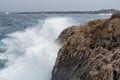 Stormy windy waves crashing on the rocks on a rocky coast