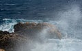 Stormy windy waves crashing on the rocks on a rocky coast