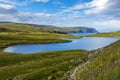 Storvatnet lake in Mageroya island. The coastline of the Barents Sea in Nord Cape direction is at background. Nordkapp Royalty Free Stock Photo