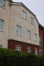 3 story apartment building with brick and white render finish UK