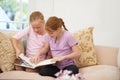 The story comes to life when you use your imagination. Two sisters reading a storybook in the lounge.