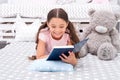 Story concept. Happy girl read interesting story. Little child ejoy bedtime story in bed. Good night story Royalty Free Stock Photo