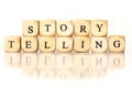 Story Telling spelled word, dice letters with reflection Royalty Free Stock Photo