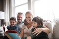 Story time with the munchkins. two adorable brothers reading a book together with their parents while relaxing on the Royalty Free Stock Photo