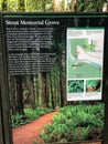 An information sign of Stout Memorial Grove,in Jebediah Smith State Park, with redwoods in the background, in California, United S