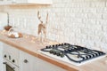 Stove in christmas kitchen. Gas-stove white kitchen furniture with christmas decor. Stylish trendy white ceramic brick wall, Royalty Free Stock Photo