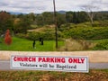 In Stowe, Vermont, USA, a funny church sign with mountains in the backdrop.