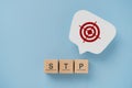 STP word ,abbreviation for Segmentation, Targeting, Positioning on wooden cube blocks. Dartboard sign on real speech bubble paper