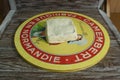 Stracchino cheese on a light wooden tray on a wooden background