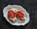 Strachatella cheese, bruschetta tomatoes on a dark background, top view Royalty Free Stock Photo