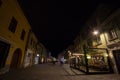 Strada Michael Weiss Street in the medieval historical center of Brasov with pedestrians passing by at night. Royalty Free Stock Photo