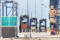 Straddle carrier picking up containers at port botany