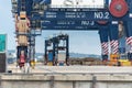 Straddle carrier picking up containers of a ship at port botany