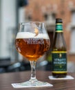Straffe Hendrik beer brand, glass and bottle, close up on a terrace Royalty Free Stock Photo