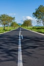 Straight asphalt road leading into the distance Royalty Free Stock Photo