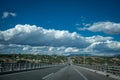 Straight asphalt road and mountain under blue sky. Highway and mountain background. Royalty Free Stock Photo