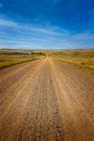 Straight dirt road between agricultural fields in Montana Royalty Free Stock Photo