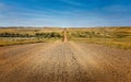 Straight dirt road between agricultural fields in Montana Royalty Free Stock Photo