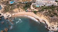 Straight down aerial photo of the beautiful town in Albufeira in Portugal showing the Praia dos Aveiros beach with and people