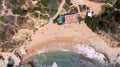 Straight down aerial photo of the beautiful town in Albufeira in Portugal showing the Praia dos Aveiros beach with and people