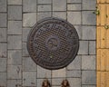 Steel manhole cover in downtown Seoul.