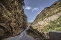 Straight empty highway leading into Xinalig village. Beautiful landscape of big Caucasus mountains and road country road with blue Royalty Free Stock Photo