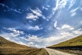 Straight empty highway leading into Xinalig village. Beautiful landscape of big Caucasus mountains and road country road with blue Royalty Free Stock Photo