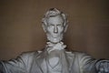 Straight on face dark portrait Of Abraham Lincoln at Memorial in Washington, DC in high contrast.