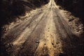 Straight ground road with dry brown dirt closeup