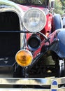 A straight head on shot of the front of a 1920`s antique car