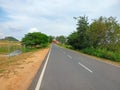 Straight highway passing from village and fields