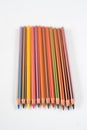 Colored pencils on white paper Royalty Free Stock Photo