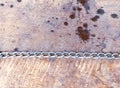 Straight line of metal chain loops on wooden background. Harmony concept