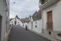 Straight narrow alley in the center of Alberobello Italian town