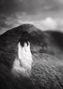 Mysterious monochrome girl in white dress shot with Lensbaby in mountains. Art shot