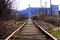 Straight railroad going to old blue factory