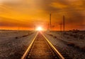 Straight railroad heading west towards the sunset somewhere in Utah