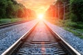 Straight Railroad into sunset with clouds in sky Royalty Free Stock Photo