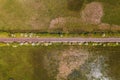 Straight railroad track through green countryside landscape in spring, drone pov