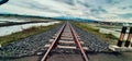 straight railroad tracks with beautiful view of the clouds Royalty Free Stock Photo