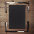 Straight razor and black picture frame on wood Royalty Free Stock Photo