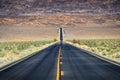 Straight road through barren desert of Death Valley National Park Royalty Free Stock Photo