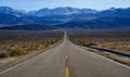 Straight Road in the California desert, going into the mountains near Death Valley National Park Royalty Free Stock Photo