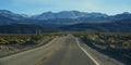 Straight Road in the California desert, going into the mountains near Death Valley National Park Royalty Free Stock Photo