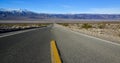 Straight Road in the California desert, going into the mountains near Death Valley National Park Royalty Free Stock Photo