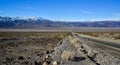 Straight Road in the California desert, going into the mountains near Death Valley National Park Royalty Free Stock Photo