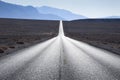 Straight road in American desert, Death Valley, California, USA Royalty Free Stock Photo